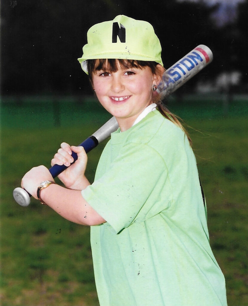 Aly Richards, as a child, playing softball.